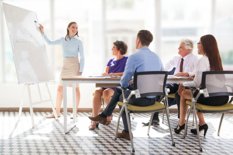 Businesswoman presenting to colleagues in a meeting.